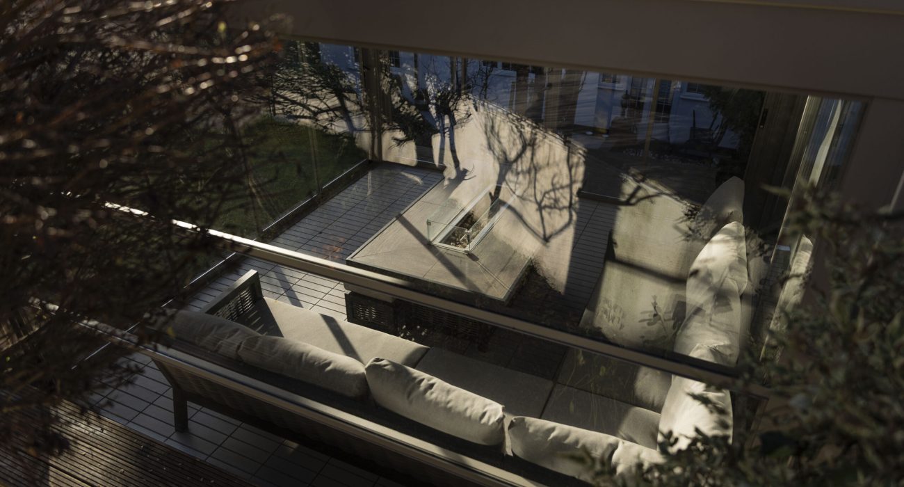 outdoor living space all year round with pergola and glass enclosure